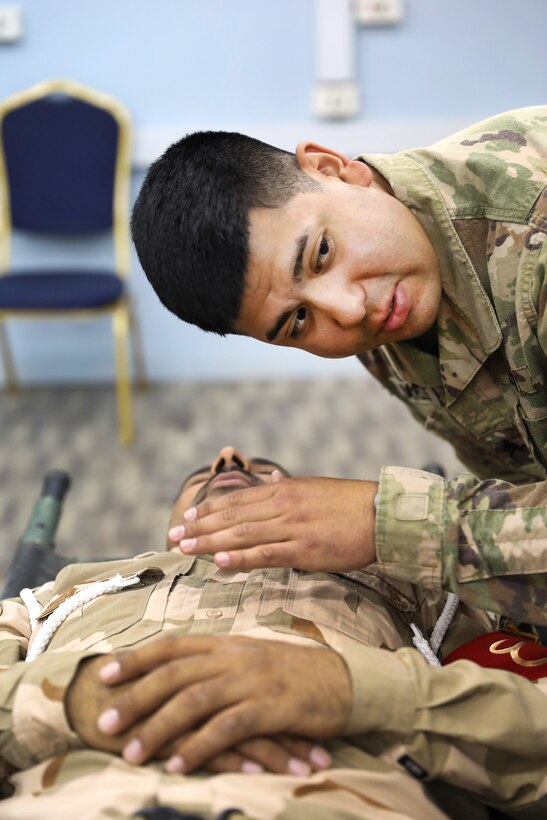 A U.S. soldier demonstrates how to check for breathing.