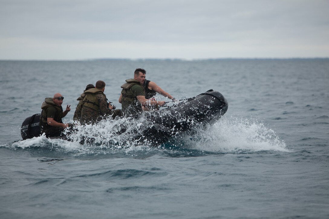 Expeditionary Operations Training Group Marines with III Marine Expeditionary Force Information Group navigate a combat rubber raiding craft to a drop zone, June 1, 2018, at White Beach Naval Facility, Okinawa, Japan. Helocasting is used for inserting reconnaissance and surveillance teams in support of small boat operations. (U.S. Marine Corps photo by Lance Cpl. Zackary Walker)