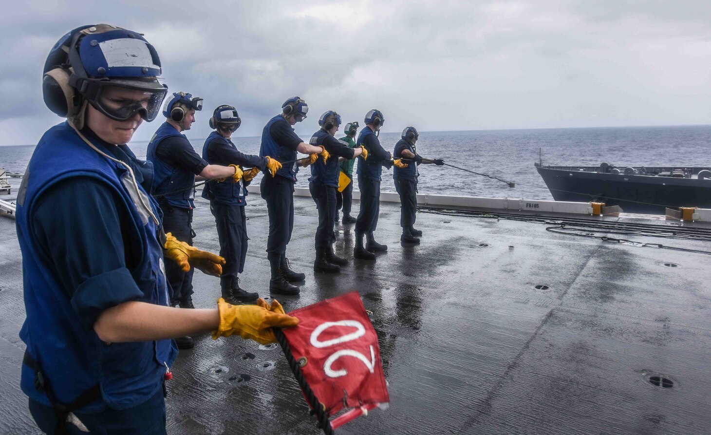 Midshipmen man the phone and distance line aboard the forward-deployed aircraft carrier, USS Ronald Reagan (CVN 76), during a replenishment at sea with the Military Sealift Command Dry Cargo and Ammunition Ship USNS Charles Drew (T-AKE 10). Eighteen midshipmen are embarked aboard Ronald Reagan as part of a training program designed to familiarize the students with real-world shipboard operations. Ronald Reagan, the flagship of Carrier Strike Group 5, provides a combat-ready force that protects and defends the collective maritime interests of its allies and partners in the Indo-Pacific region.