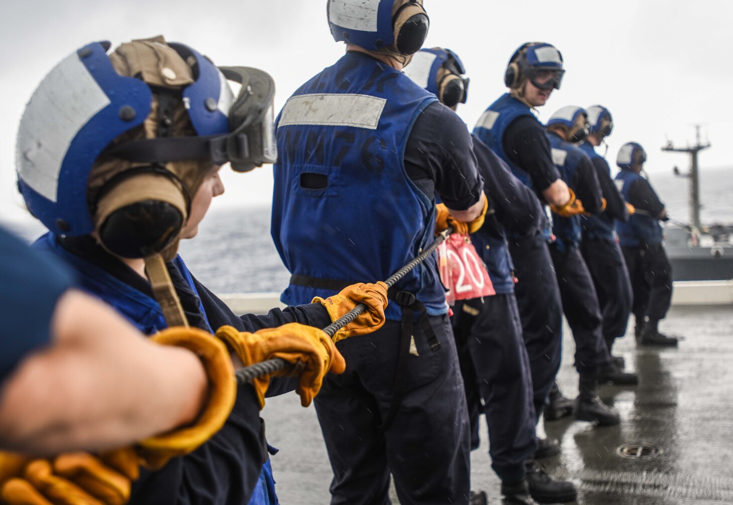 Midshipmen man the phone and distance line aboard the forward-deployed aircraft carrier, USS Ronald Reagan (CVN 76), during a replenishment at sea with the Military Sealift Command Dry Cargo and Ammunition Ship USNS Charles Drew (T-AKE 10). Eighteen midshipmen are embarked aboard Ronald Reagan as part of a training program designed to familiarize the students with real-world shipboard operations. Ronald Reagan, the flagship of Carrier Strike Group 5, provides a combat-ready force that protects and defends the collective maritime interests of its allies and partners in the Indo-Pacific region.