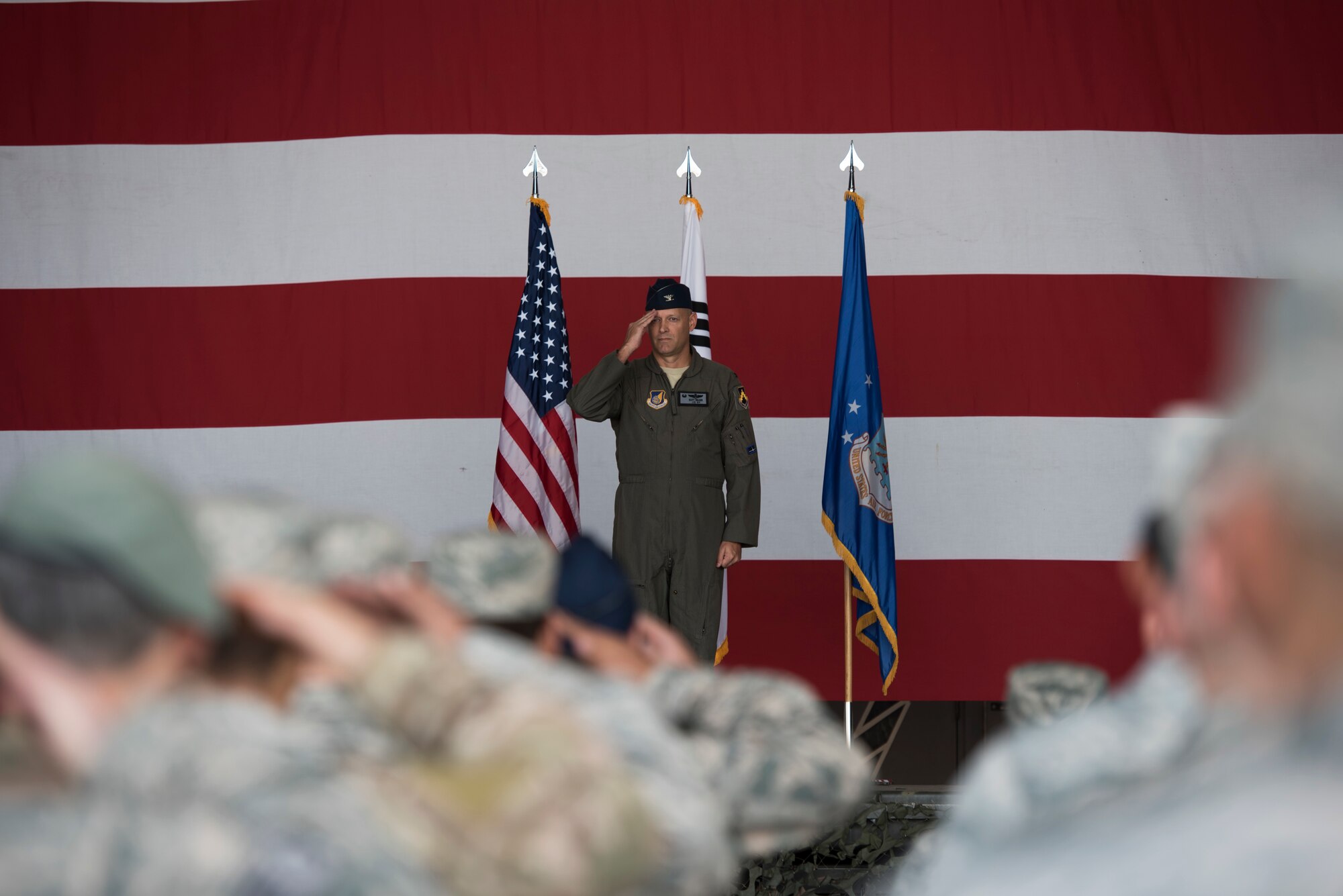 Members of the Wolf Pack render the initial salute to U.S. Air Force Col. Scott Walker, 8th Operations Group commander, at an assumption of command ceremony June 5, 2018, at Kunsan Air Base, Republic of Korea. The 8th OG is responsible for conducting airfield and air operations in support of the Korean theater of operations, flight scheduling, and ensuring the operational readiness of two F-16 Fighting Falcon squadrons stationed at Kunsan. (U.S. Air Force photo by Staff Sgt. Levi Rowse)