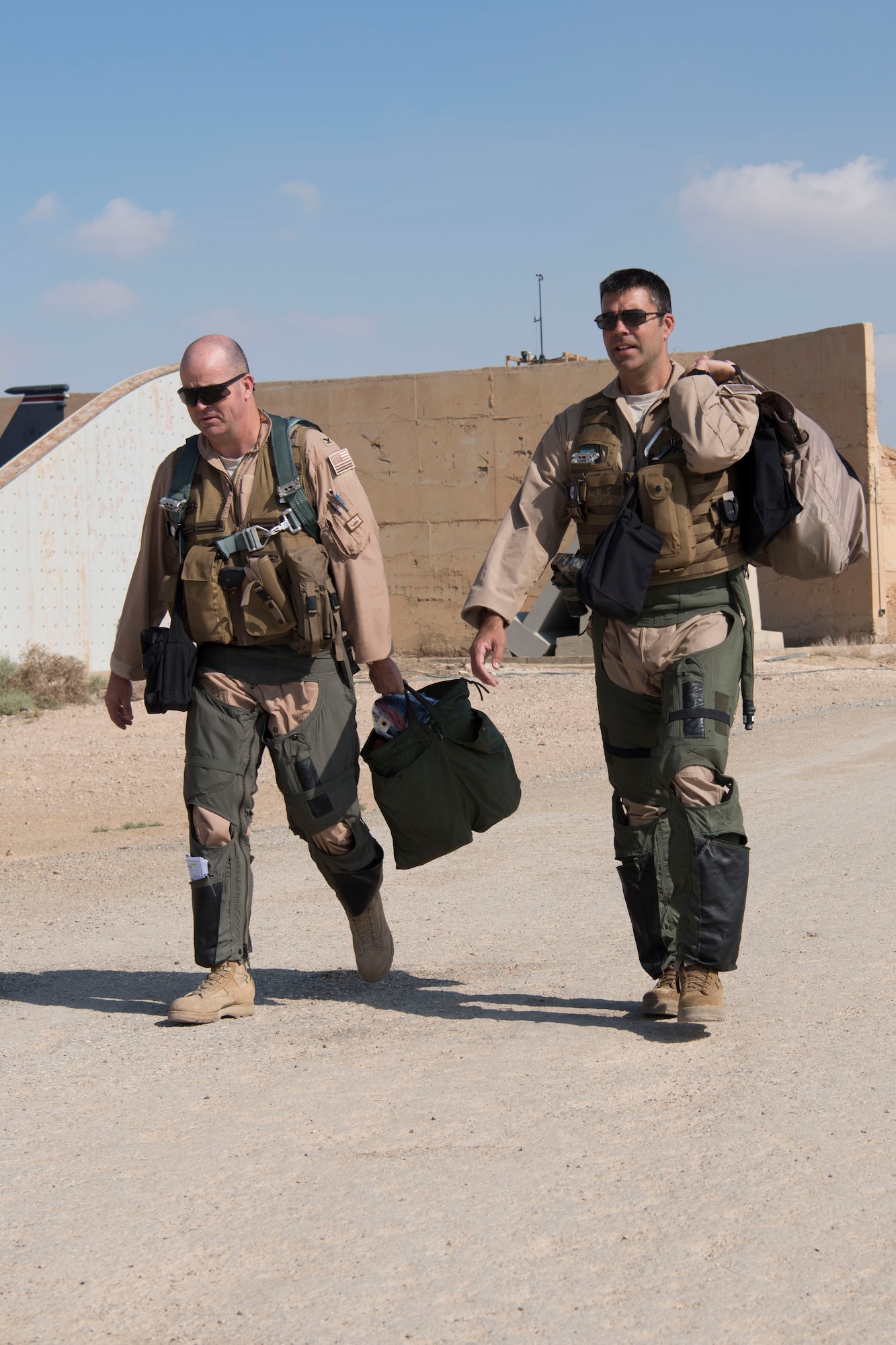 Col. William Marshall, 332nd Expeditionary Operations Group commander, and Col. Richard Goodman, 332nd Air Expeditionary Wing vice commander, walk to an F-15E Strike Eagle, June 2, 2018, at an undisclosed location in Southwest Asia