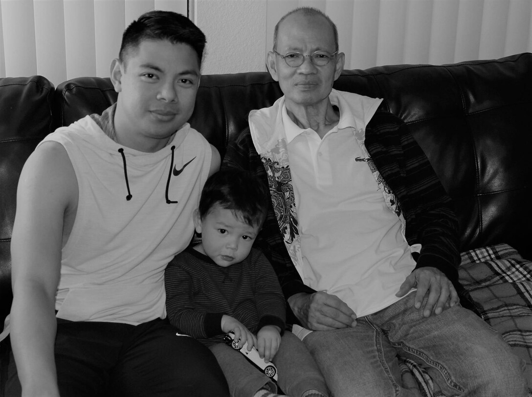 U.S. Air Force Staff Sgt. Paolo Alix, 39th Logistics Readiness Squadron material management journeyman, his son, Syrus Alix, two, and Paolo’s father Efren Alix, take a family picture on Efren’s first night in the United States.