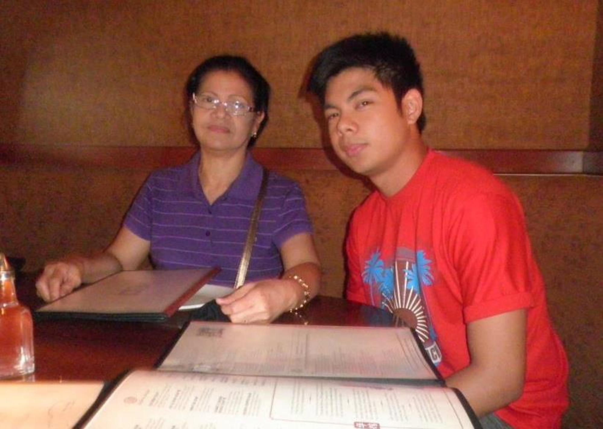 U.S. Air Force Staff Sgt. Paolo Alix, 39th Logistics Readiness Squadron material management journeyman, has dinner with his mom, Celia Alix, before leaving for Basic Military Training in August 2011.