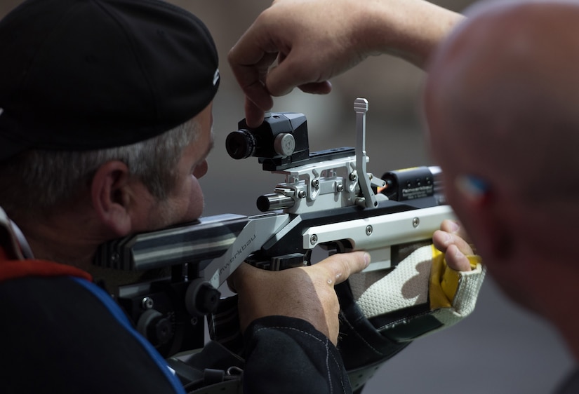 Kevin Nanson of Team Canada makes adjustments to his rifle with assistance from his coach during shooting practice at the 2018 Defense Department Warrior Games at the U.S, Air Force Academy in Colorado Springs, Colo., May 30, 2018. DoD photo by Staff Sgt. Carlin Leslie