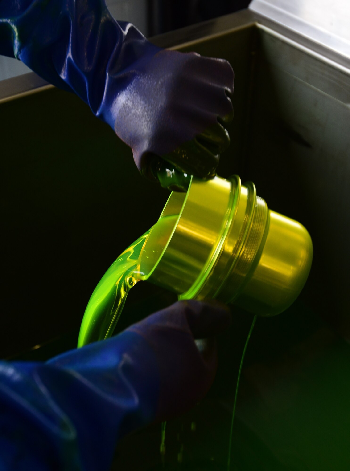 A U.S. Air Force nondestructive inspection specialist from the 325th Maintenance Squadron covers a metal component in fluorescent chemicals at Tyndall Air Force Base, Fla., May 23, 2018. Utilizing everything from x-rays to ultrasound, nondestructive inspection specialists find the smallest imperfections and take corrective measures needed to keep Air Force equipment working safely. (U.S. Air Force photo by Senior Airman Cody R. Miller/Released)