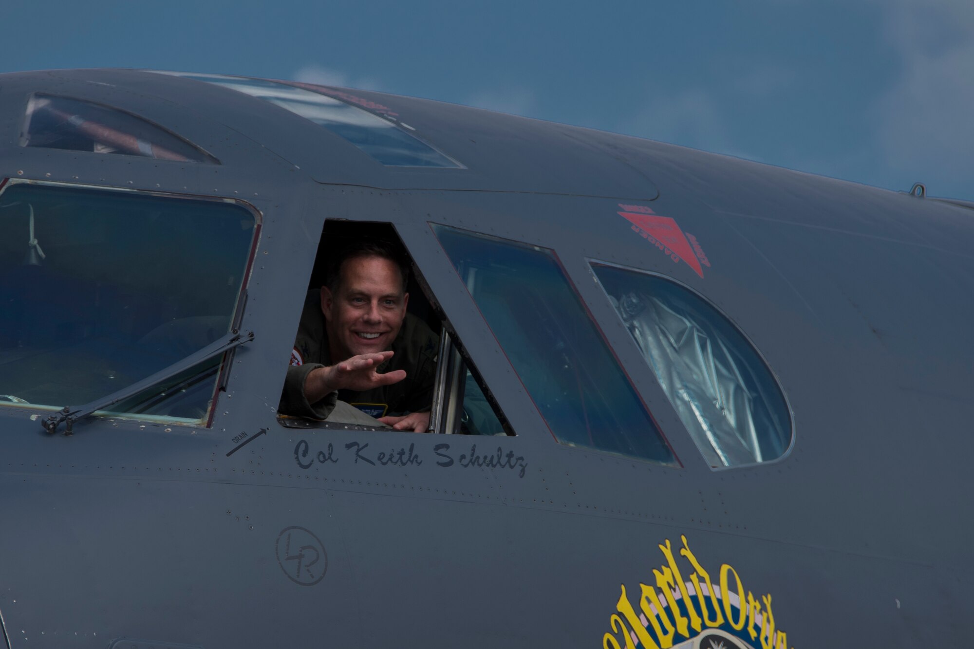 U.S. Air Force Col. Christopher Anderson, vice commander of the 307th Bomb Wing, waves to family, friends, and fellow Airmen out of the cockpit window of a B-52 Stratofortress at Barksdale Air Force Base, Louisiana, June 1, 2018. Anderson celebrated the conclusion of his final flight with the unit before moving on to his next assignment.   (U.S. Air Force photo by Airman Maxwell Daigle/Released)