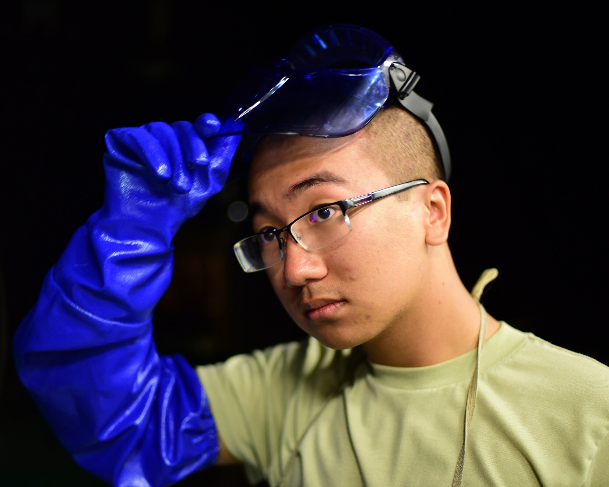 U.S. Air Force Airman Bryan Pham, 325th Maintenance Squadron nondestructive inspection specialist, dons protective gear before inspecting components at Tyndall Air Force Base, Fla., May 1, 2018. Nondestructive inspection specialists are responsible for employing noninvasive methods to inspect the insides of metal objects and identifying possible defects in systems and equipment to prevent accidents. (U.S. Air Force photo by Senior Airman Cody R. Miller/Released)
