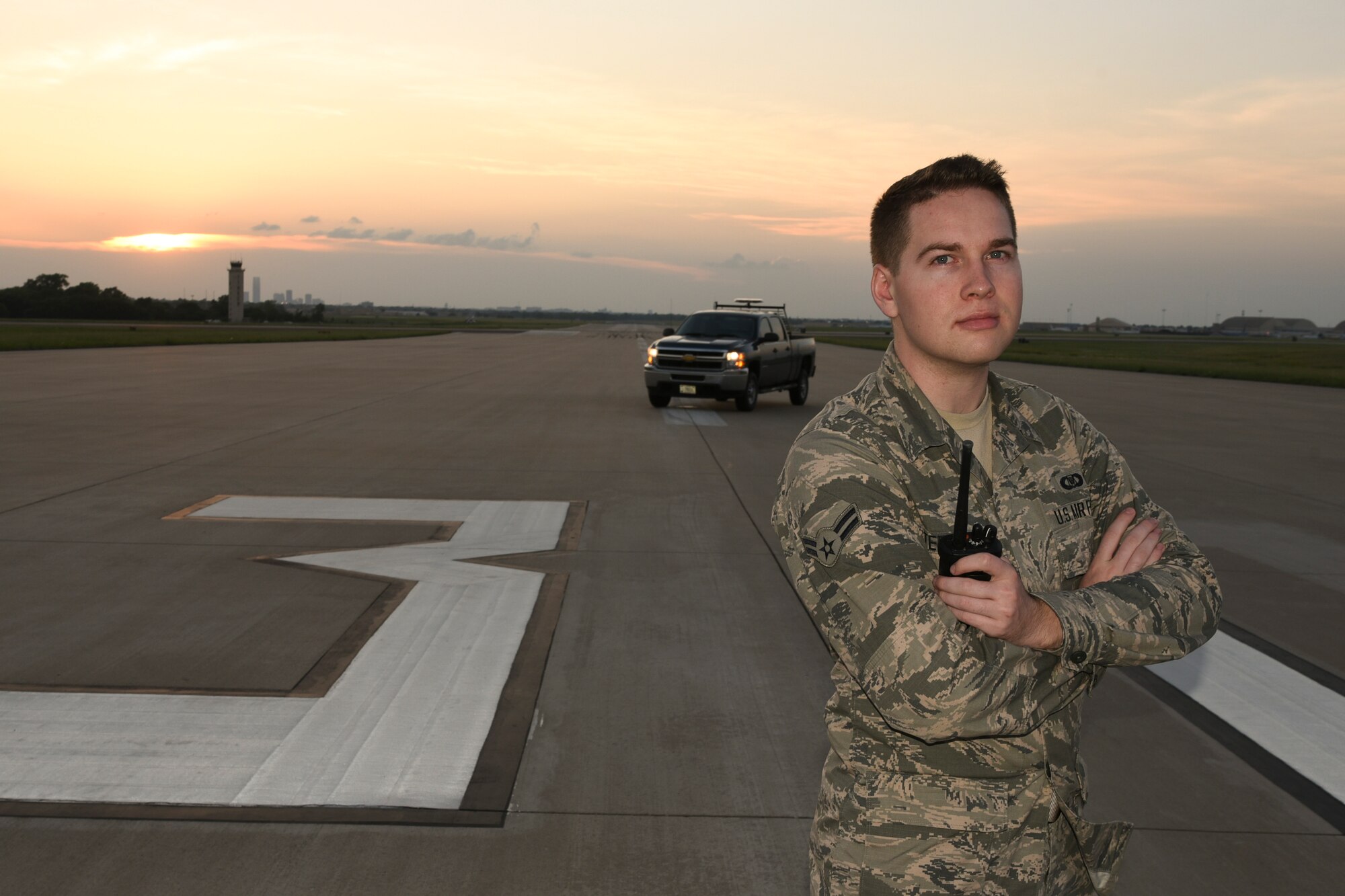 Airman 1st Class Casey Stephenson, 72nd Operations Support Squadron airfield management, stands on the approach end of Runway 31 during a late evening inspection of airfield lighting and search for foreign object debris May 23, 2018, Tinker Air Force Base, Oklahoma.