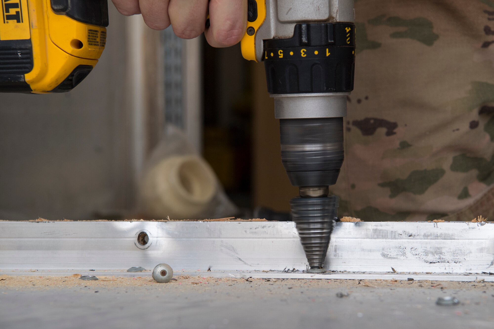 A 386th Expeditionary Civil Engineer Squadron water and fuel systems maintenance Airman removes bolts from the inside of a shipping container at an undisclosed location in Southwest Asia, May 13, 2018. A wall in the middle of the container was removed in order to install a water filtration unit used at the dining facility. (U.S. Air Force photo by Staff Sgt. Joshua King)