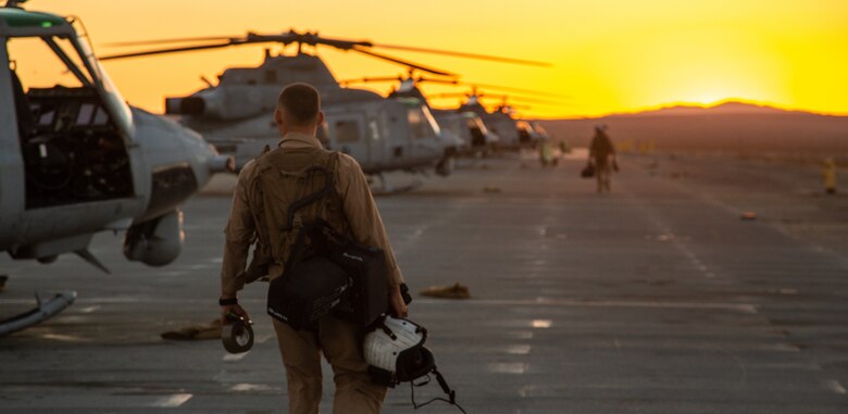 A pilot with Light Attack Helicopter Squadron 367, also known as ‘Scarface’, heads toward the UH-1Y Venom Utility helicopters for a nighttime flight mission during the Final Exercise of Integrated Training Exercise 3-18 aboard the Marine Corps Air Ground Combat Center, Twentynine Palms, Calif., May 23, 2018. Marine aviation provides the Marines of the Marine Air Ground Task Force the operational flexibility it needs to accomplish their mission. (U.S. Marine Corps photo by Lance Cpl. Dave Flores)