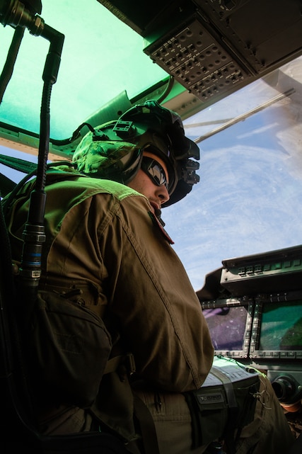 A pilot with Light Attack Helicopter Squadron 367, also known as ‘Scarface’, listens to a fellow pilot while on a flight mission during the Final Exercise of Integrated Training Exercise 3-18 aboard the Marine Corps Air Ground Combat Center, Twentynine Palms, Calif., May 23, 2018. Marine aviation provides the Marines of the Marine Air Ground Task Force the operational flexibility it needs to accomplish their mission. (U.S. Marine Corps photo by Lance Cpl. Dave Flores)