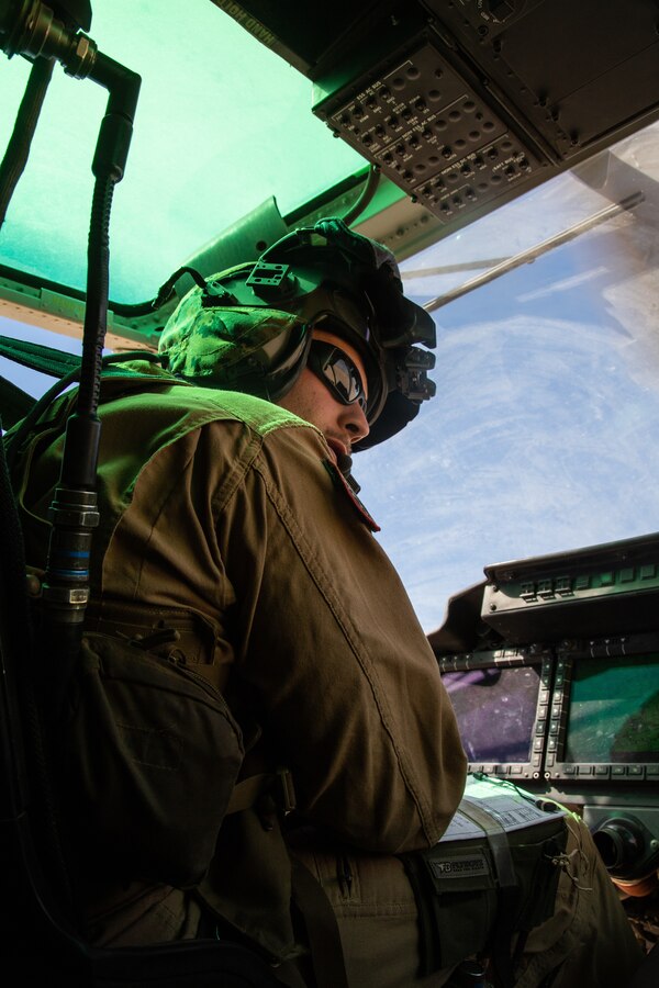 A pilot with Light Attack Helicopter Squadron 367, also known as ‘Scarface’, listens to a fellow pilot while on a flight mission during the Final Exercise of Integrated Training Exercise 3-18 aboard the Marine Corps Air Ground Combat Center, Twentynine Palms, Calif., May 23, 2018. Marine aviation provides the Marines of the Marine Air Ground Task Force the operational flexibility it needs to accomplish their mission. (U.S. Marine Corps photo by Lance Cpl. Dave Flores)