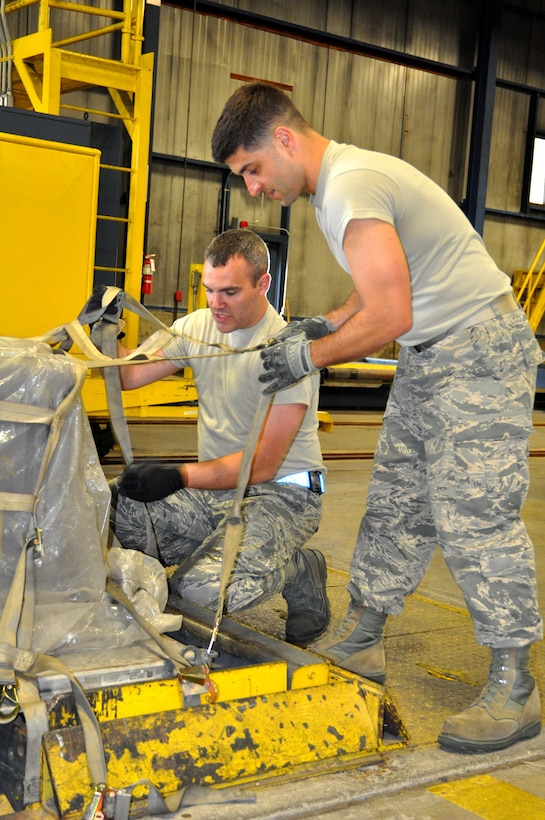 Senior Master Sgts. Brian Cronin, left, and Michael Eonta work together to attach a net to a cargo pallet. The Airmen participated in multiple timed training events throughout the day, designed to bring hands-on practice to Reserve Citizen Airmen of all ranks during the 87th Aerial Port Squadron Port Dawg Challenge conducted May 5, 2018.