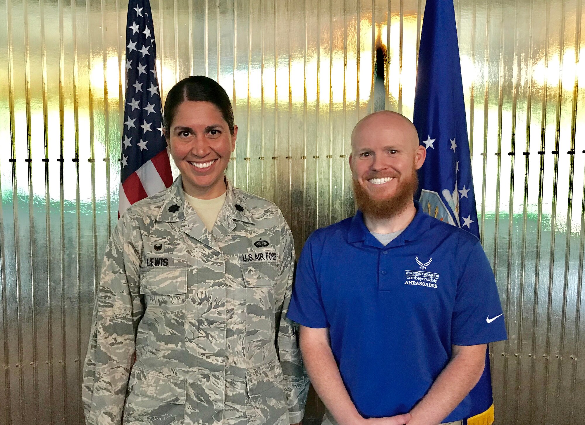 U.S. Air Force Lt. Col. Summer Lewis, 21st Force Support Squadron commander, stands with retired Staff Sgt. Cory Sandoval following a commander’s call at Peterson Air Force Base, Colorado, June 4, 2018. Sandoval shared his story with the squadron while sharing how the Air Force Wounded Warrior Program saved his life following a tragic accident several years ago. (U.S. Air Force photo by Alexx Pons)