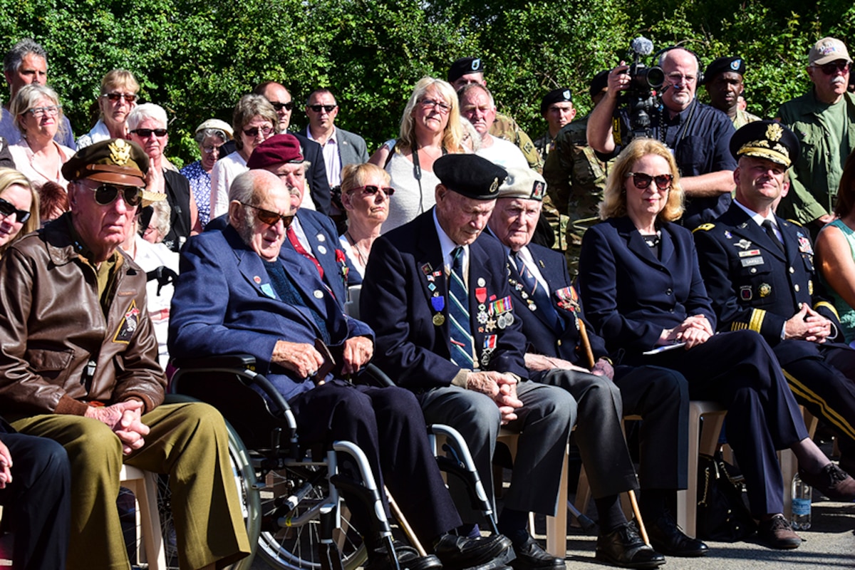 A group of people watch a ceremony.