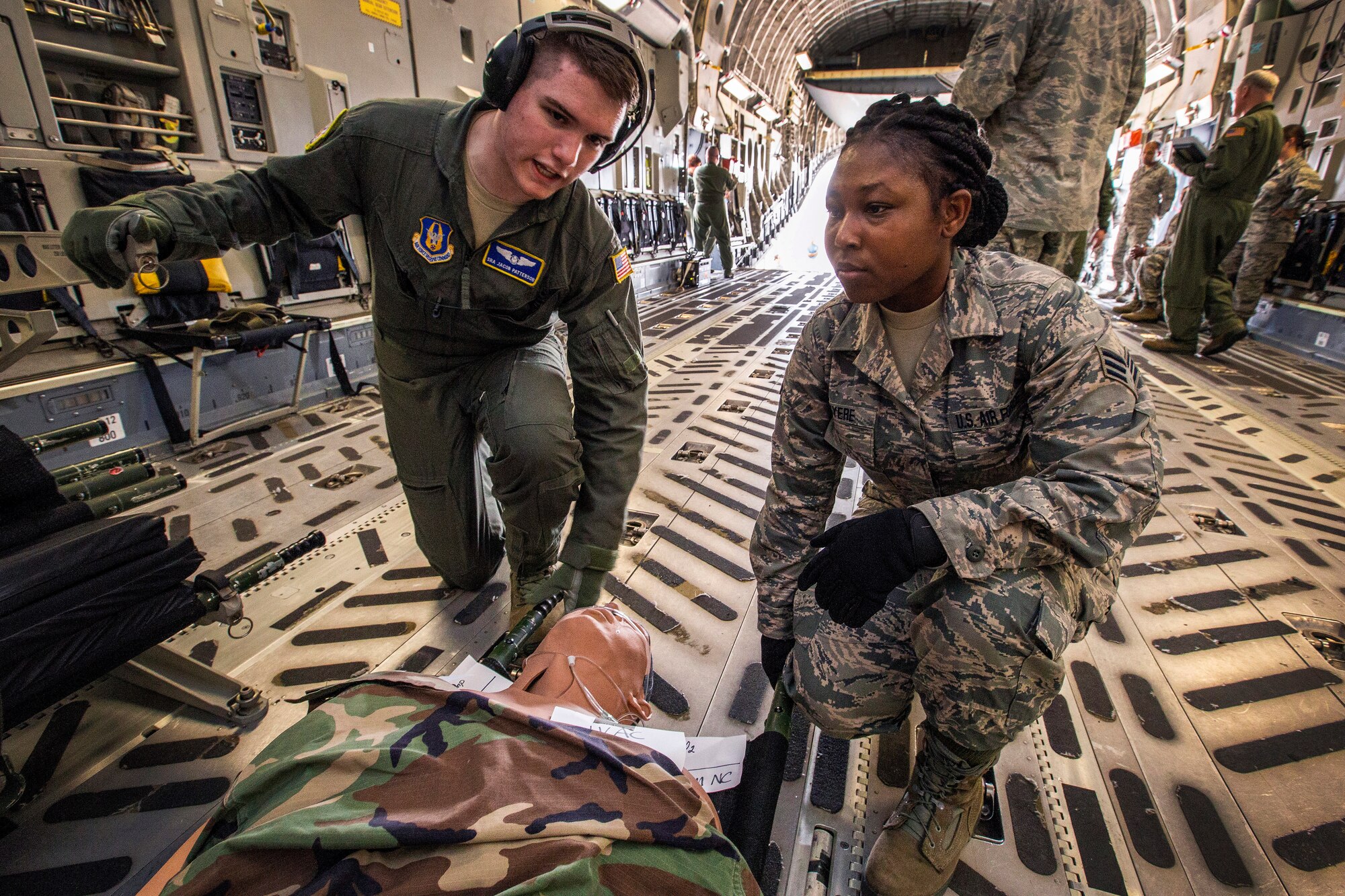 U.S. Air Force Senior Airman Selina N. Okyere, right, and Senior Airman Jacob Patterson, both with the 514th Aeromedical Evacuation Squadron, 514th Air Mobility Wing, prepare to load a patient on a C-17 Globemaster III during an exercise at Joint Base McGuire-Dix-Lakehurst, N.J., June 2, 2018. The 514th is an Air Force Reserve Command unit. (U.S. Air Force photo by Master Sgt. Mark C. Olsen)