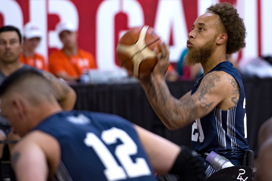 A person in a wheelchair throws a basketball.