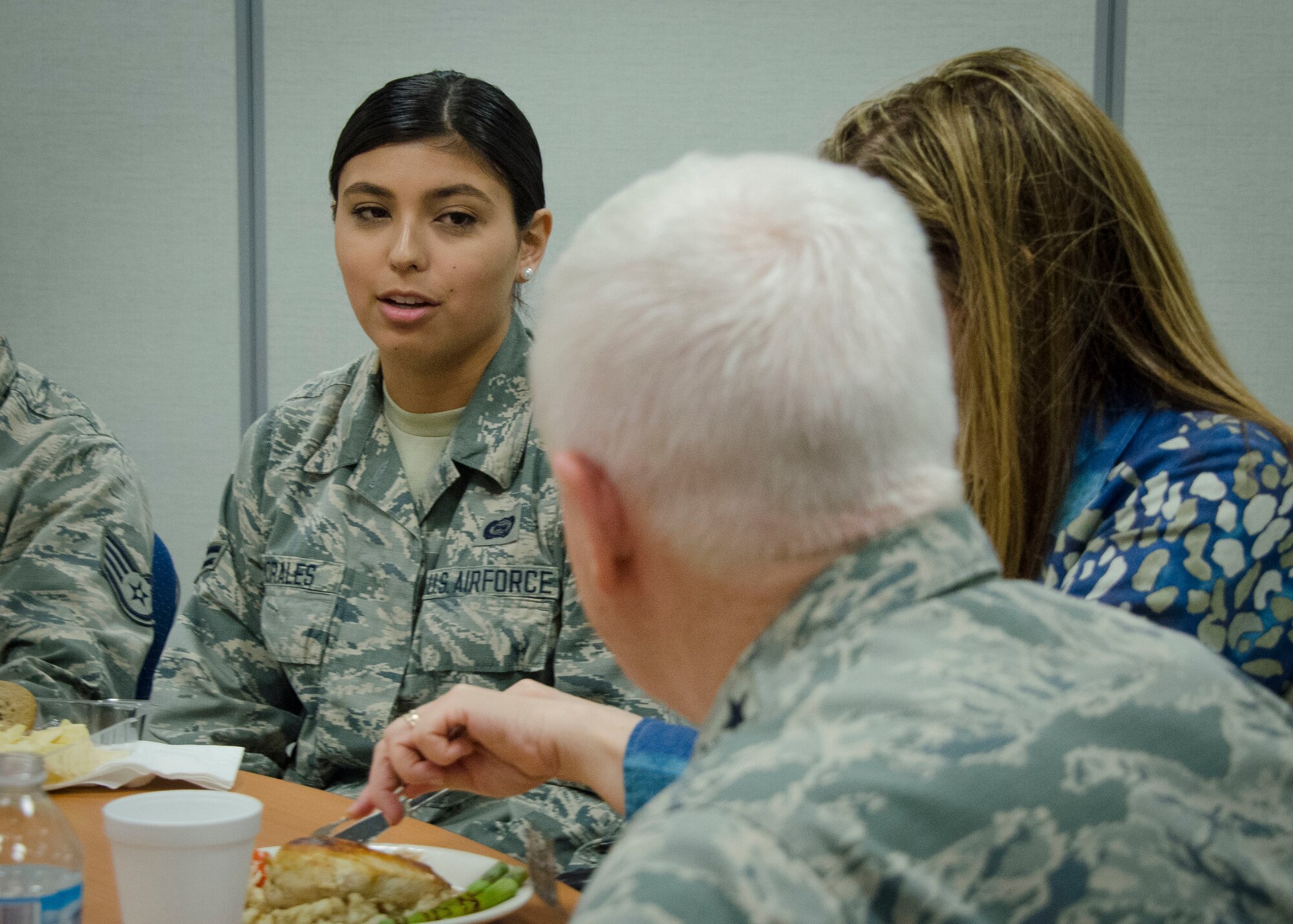 Lt. Gen. L. Scott Rice, the director of the Air National Guard, listens to Airmen Adriana Morales, a intelligence analyst with the 128th Operations Support Squadron at the 128th Air Refueling Wing, Milwaukee WI.