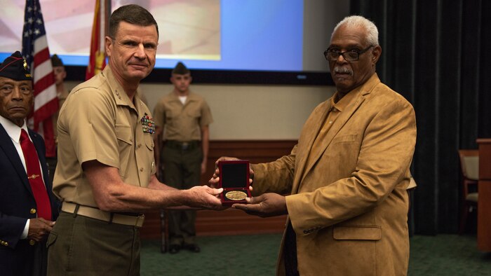 Lt. Gen. William D. Beydler, commander of Marine Corps Force Central Command, presents Clement E. Hill with the Congressional Gold Medal in honor of his late father Pfc. Burnie W. Hill, May 31, 2018 at MacDill Air Force Base, Florida. In 1942, African Americans were given the opportunity to enlist in the United States Marine Corps. Nearly 20,000 African Americans from 1942-1949 were trained separately from their white counterparts at Montford Point, a facility at Camp Lejeune, North Carolina.