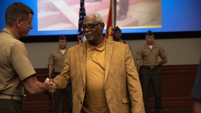 Clement E. Hill shakes hands with Lt. Gen. William D. Beydler, commander of Marine Corps Forces Central Command, after a Congressional Gold Medal Award Ceremony, May 31, 2018 at MacDill Air Force Base, Florida. Hill accepted the award in honor of his late father Pfc. Burnie W. Hill, a Montford Point Marine. In 1942, African Americans were given the opportunity to enlist in the United States Marine Corps. Nearly 20,000 African Americans from 1942-1949 were trained separately from their white counterparts at Montford Point, a facility at Camp Lejeune, North Carolina.