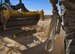 Tech. Sgt. Robert Brousseau, 99th Civil Engineer Squadron explosive ordnance disposal technician, uses a strap to guide a Mark 82 bomb during an ammunition disposition request at Nellis Air Force Base, Nevada, May 31, 2018. EOD technicians buried the 500-pound Mark 82 bomb underground and then covered it with dirt to minimize the blast radius of fragmentation and debris. (U.S. Air Force photo by Airman 1st Class Andrew D. Sarver)