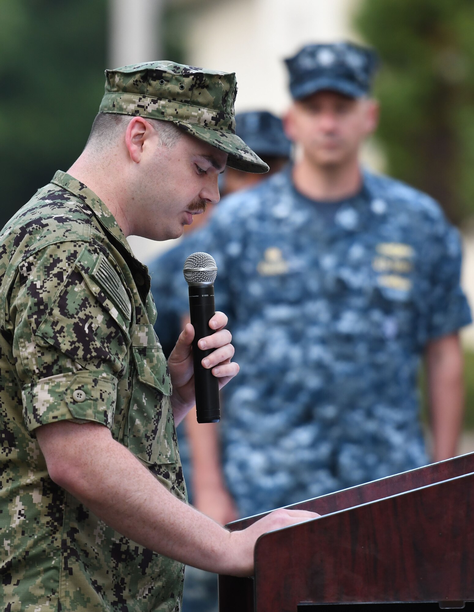 U.S. Navy Aerographers Mate 1st Class Zachary Walt, Center for Naval Aviation Technical Training Unit Keesler instructor, delivers remarks during the Battle of Midway Commemoration Ceremony hosted by the CNATTU Keesler outside of Allee Hall at Keesler Air Force Base, Mississippi, June 5, 2018. The ceremony commemorated the 76th anniversary of the Battle of Midway. (U.S. Air Force photo by Kemberly Groue)
