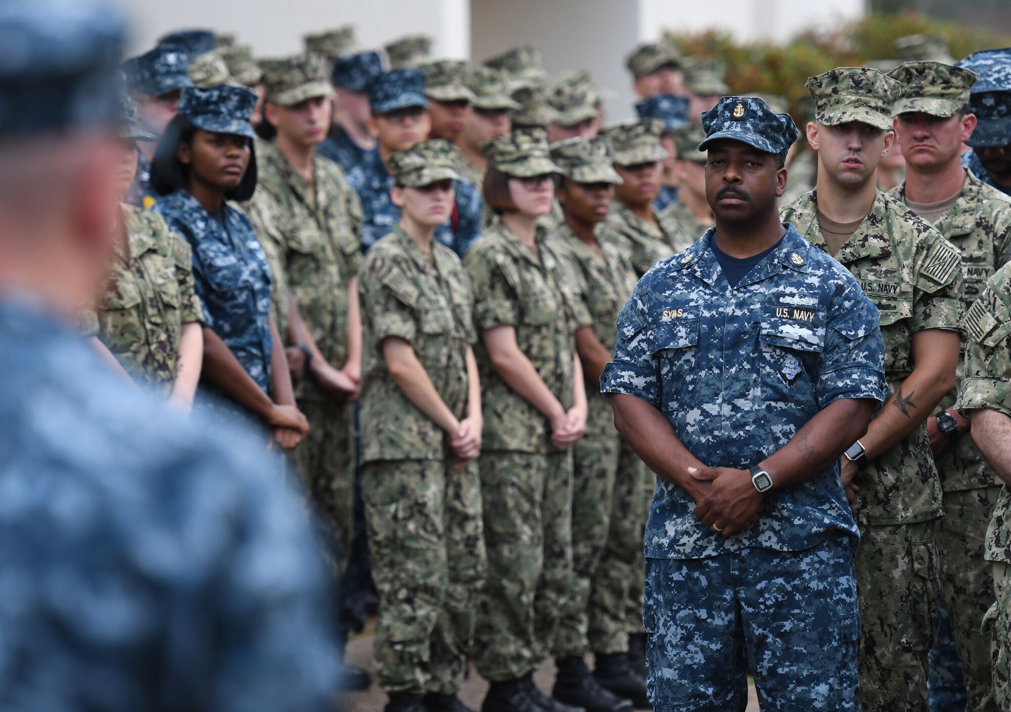 U.S. Navy Chief Electricians Mate Andre Syas, Center for Naval Aviation Technical Training Unit Keesler calibration department lead, stands in formation during the Battle of Midway Commemoration Ceremony hosted by the CNATTU Keesler outside of Allee Hall at Keesler Air Force Base, Mississippi, June 5, 2018. The ceremony commemorated the 76th anniversary of the Battle of Midway. (U.S. Air Force photo by Kemberly Groue)
