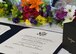The certificate of retirement for James Kellogg, Jr., 94th Airlift Wing vice commander, sits on a presentation table flanked by flowers and a gift at Dobbins Air Reserve Base, Ga, June 2, 2018. The certificate was presented to the newly retired vice commander during his retirement ceremony, marking the end of a 30-year career in the Air Force. (U.S. Air Force photo by Staff Sgt. Miles Wilson)