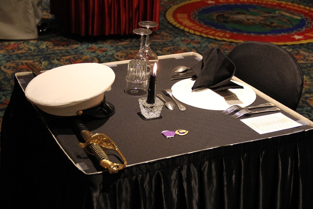 U.S. ARMY GARRISON YONGSAN – A table with inverted plate, lit candle, and Purple Heart Medal represents Marines who could not be present due to their personal sacrifice in the service of the United States at the U.S. Marine Corps Forces Korea “Dining Out” here, June 2.  MARFORK conducted the formal military dinner to build comradery, remember the sacrifices of those who came before them, and celebrate their military service together.  (U.S. Marine Corps photo by U.S. Marine Corps Forces Korea staff /Released)