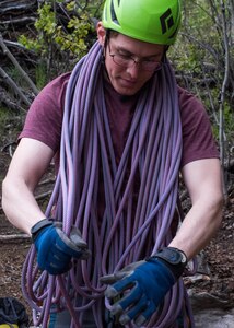 Fernando Martinez Batiz, an Outdoor Adventure Program recreational assistant, gathers climbing rope after an OAP rock-climbing trip at Pivot Point Trail near Anchorage, Alaska, May 31, 2018. Martinez Batiz has been climbing for more than three years and works with OAP on guided events and classes. The OAP offers low-cost opportunities for the Joint Base Elmendorf-Richardson community to explore Alaska while also supporting the development of mission-ready military members.