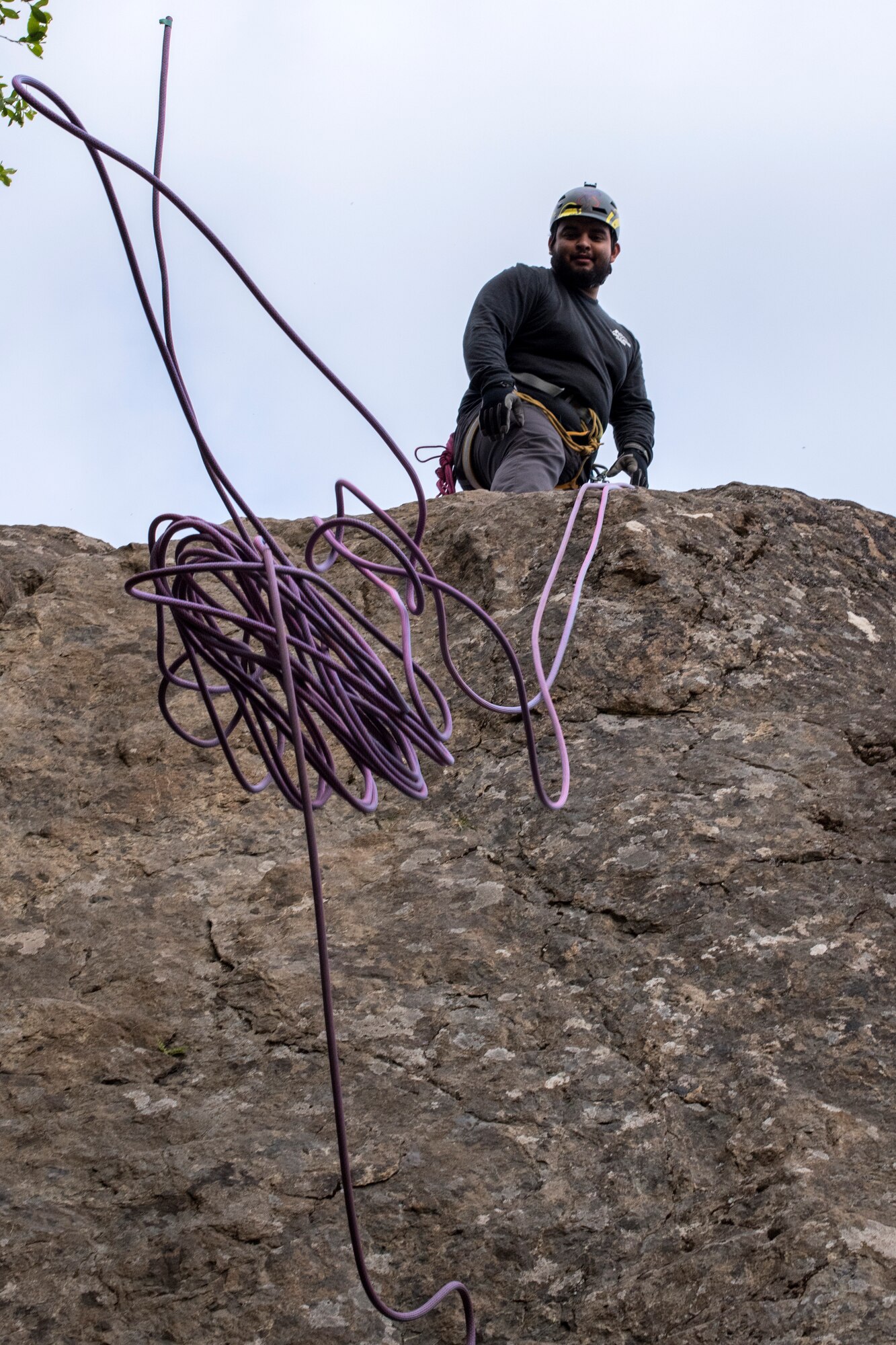 Christian Ortega, an Outdoor Adventure Program recreational assistant, throws climbing rope down after an OAP rock-climbing trip at Pivot Point Trail near Anchorage, Alaska, May 31, 2018. Ortega has been climbing for more than five years and has and internship with OAP on guided events and classes. The OAP offers low-cost opportunities for the Joint Base Elmendorf-Richardson community to explore Alaska while also supporting the development of mission-ready military members.