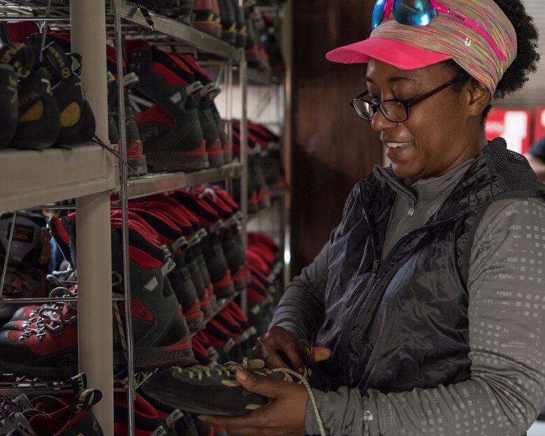 Army Maj. Adrien Humphreys, a member of the 611th Air Operations Center current operations team, picks up rock-climbing shoes before a climbing trip scheduled with the Outdoor Adventure Program at Joint Base Elmendorf-Richardson, Alaska, May 31, 2018. Humphreys has participated in many of OAP’s guided events since being stationed at JBER but has never climbed rock. The OAP offers many opportunities year-round for the JBER community to explore Alaska while also supporting the development of mission-ready military families and members.