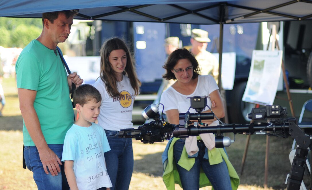 A German family stops to learn more about the 773rd Civil Support Team'