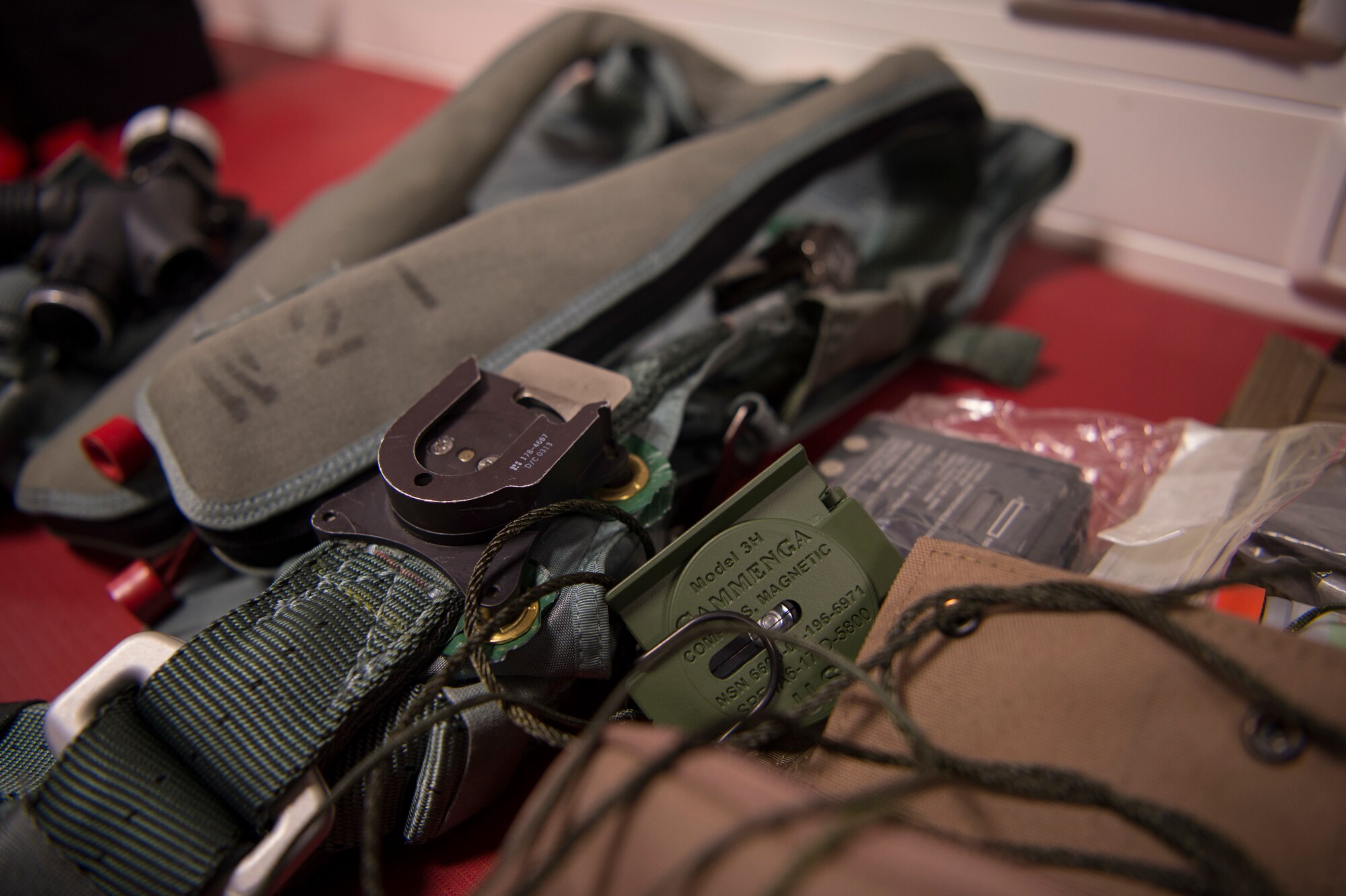 The survival kit includes an extra radio, signal flares, first aid kit, a compass, survival knife, drinking water, blanket, matches, strobe light, and a beacon.
