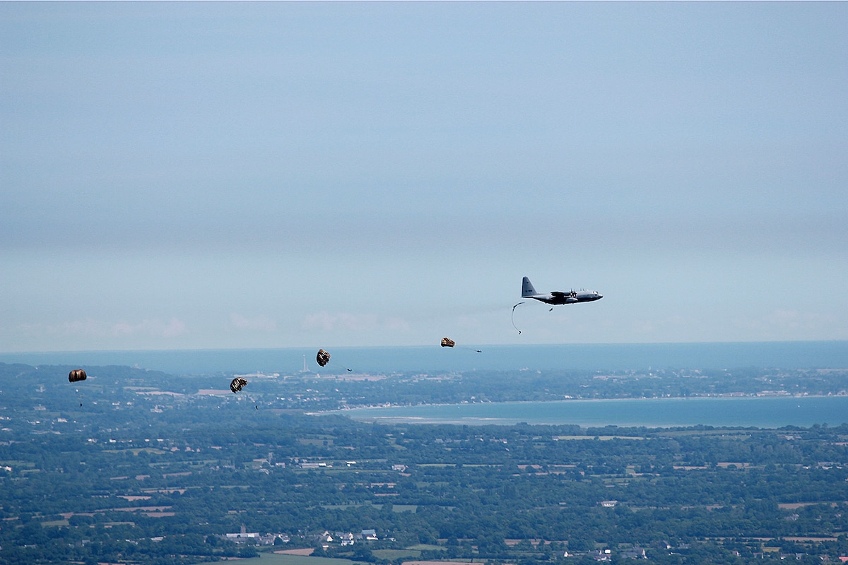 Paratroopers drop from a C-130 Hercules aircraft during commemoration ceremonies for the 74th anniversary of D-Day.