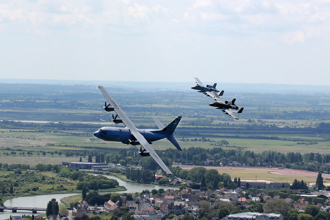 Aircraft fly over Normandy, France commemorating the first mission for the 107th Fighter Squadron in France since World War II.