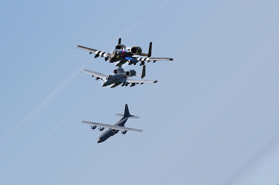 A-10 Thunderbolt II aircraft from the 107th Fighter Squadron, Michigan Air National Guard are joined by a C-130 Hercules aircraft as they fly over the beaches of Normandy, France.