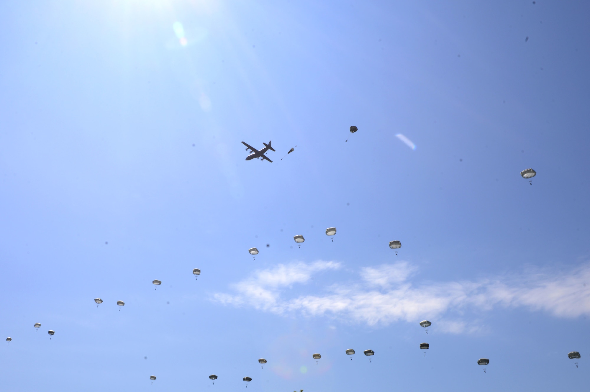 A U.S. Air Force C-130J Super Hercules drops paratroopers over Sainte-Mère-Église, France, June 3, 2018. U.S. and Allied aircraft conducted memorial airdrops to commemorate the Battle of Normandy in World War II. (U.S. Air Force photo by Senior Airman Joshua Magbanua)