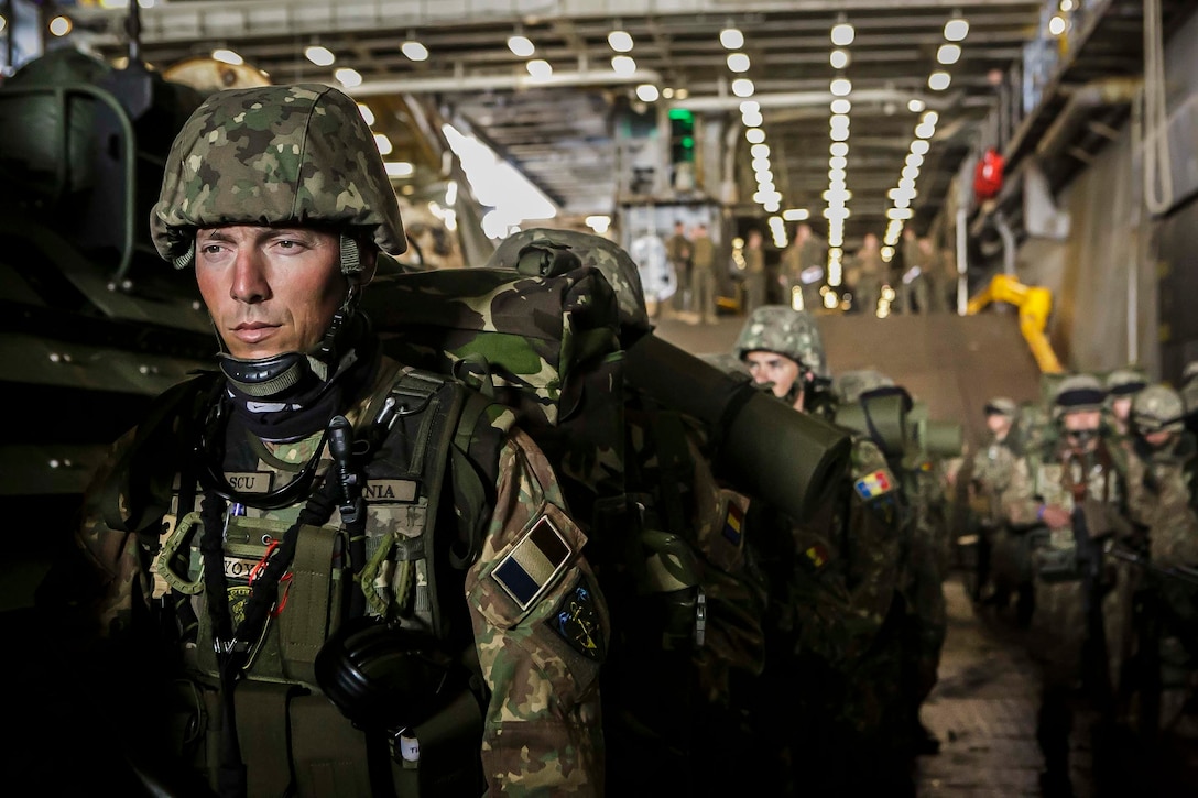 Romanian Marines assigned to the 307th Naval Infantry Battalion and U.S. Marines and Sailors assigned to Fox Company, Battalion Landing Team, 2nd Battalion, 6th Marine Regiment, 26th Marine Expeditionary Unit, line up in the well deck of the Harpers Ferry-class dock landing ship USS Oak Hill to mount designated AAV-P7/A1 assault amphibious vehicles prior to a multilateral amphibious landing during exercise Baltic Operations 2018 in the Baltic Sea June 4. BALTOPS is the premier annual maritime-focused exercise in the Baltic region and one of the largest exercises in Northern Europe enhancing flexibility and interoperability among allied and partner nations.