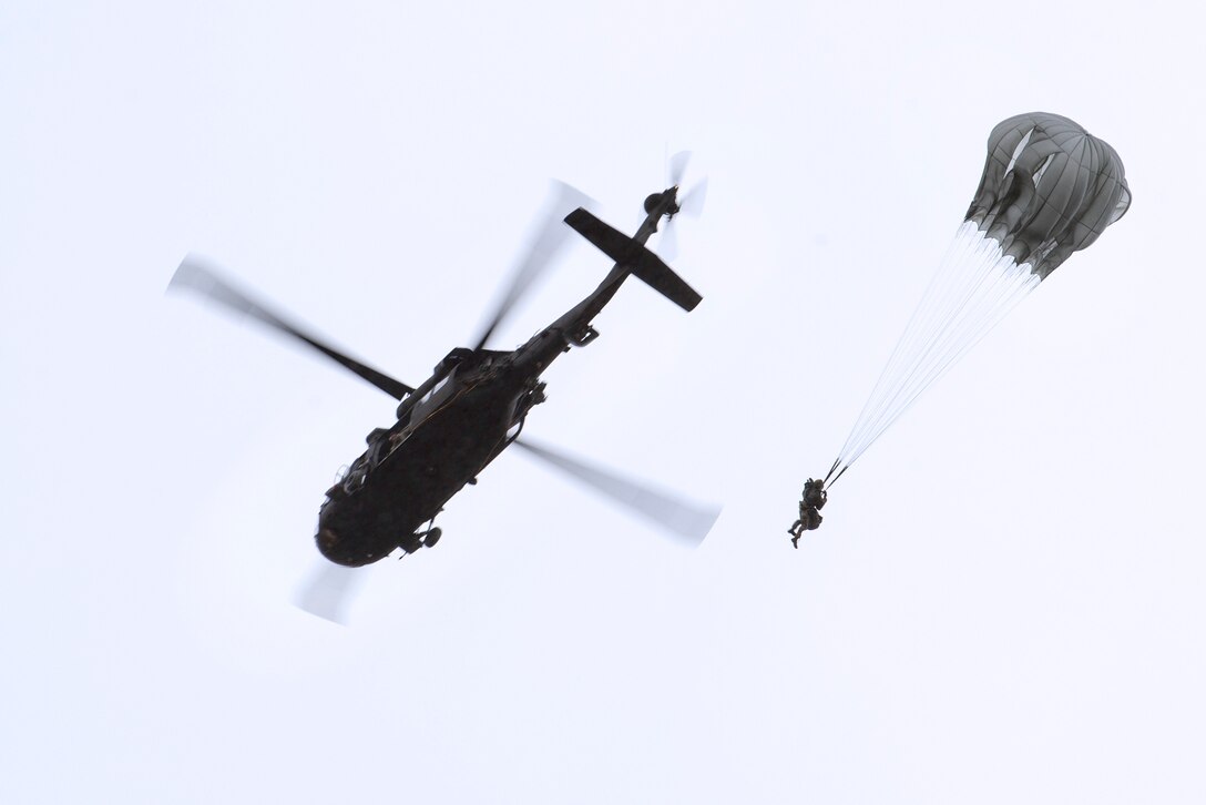 Airmen and soldiers conduct airborne operation from a UH-60 Black Hawk helicopter.