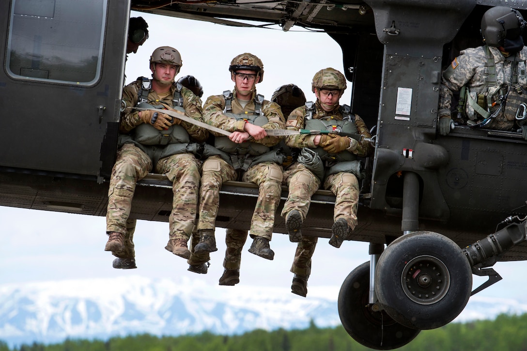 Airmen take off in an Army UH-60 Black Hawk helicopter.