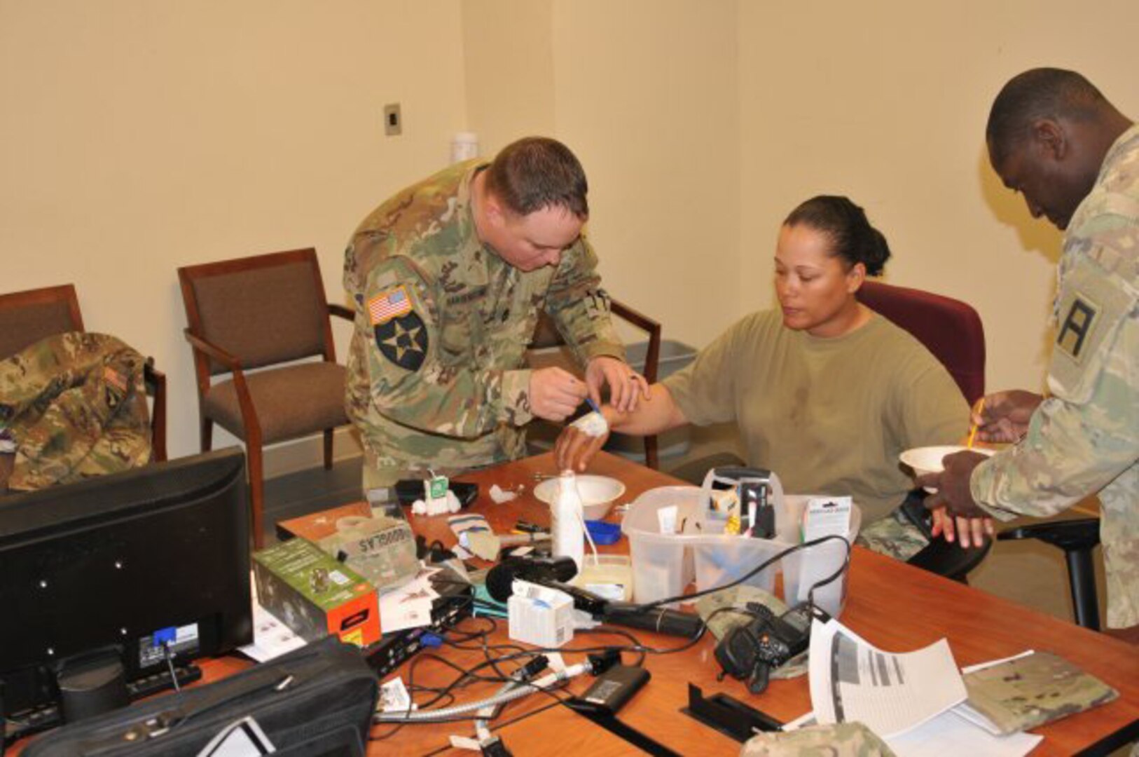 Sgt. 1st Class Jessica Douglas works with other First Army Soldiers during a moulage class while supporting the 155th Armored Brigade Combat Team's mobilization and validation exercise at Fort Bliss, Texas. Douglas, who is self-taught, used her knowledge to provide insight and training to other OC/Ts to enhance the realism of potential wounds suffered on the battlefield.