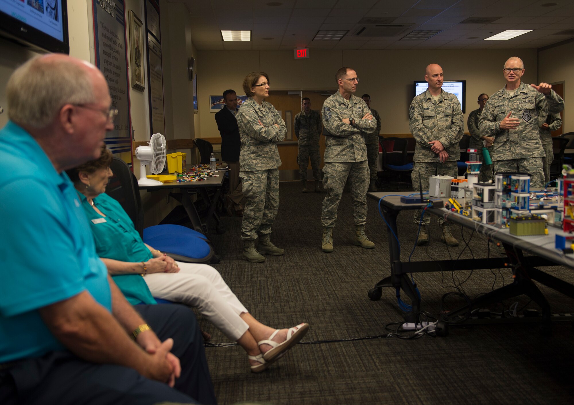 Maj. Gen. Chris Weggeman, 24th Air Force commander (right), explains the purpose of the 90th Cyber Operations Squadron “Bricks-in-the-Loop” model to civic leaders during a tour at Joint Base San Antonio-Lackland, Texas, May 31, 2018. The model is used as a cyber training tool to teach cyber Airmen information technology and operational technology network defense. The tour was hosted to introduce attendees to 24th Air Force's cyberspace mission and 25th AF's intelligence, surveillance and reconnaissance mission. (U.S. Air Force photo by Tech. Sgt. R.J. Biermann)