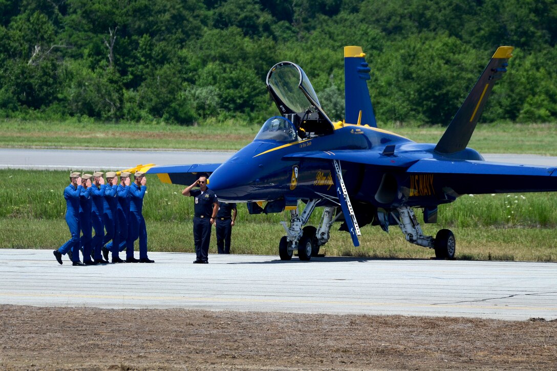 Navy pilots walk down the flightline before a practice demonstration.