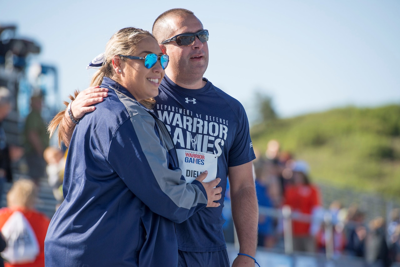 Medically retired Navy Petty Officer 3rd Class Anthony Dieli is congratulated by his wife, Carolina, after running in a 400-meter race during the 2018 Defense Department Warrior Games at the U.S. Air Force Academy in Colorado Springs, Colo., June 2, 2018. DoD photo by Roger L. Wollenberg