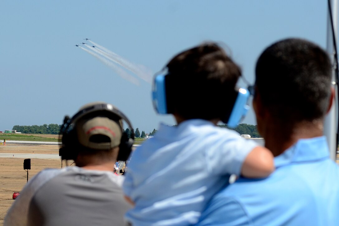 Spectators watch the U.S. Navy Blue Angels perform a practice demonstration.