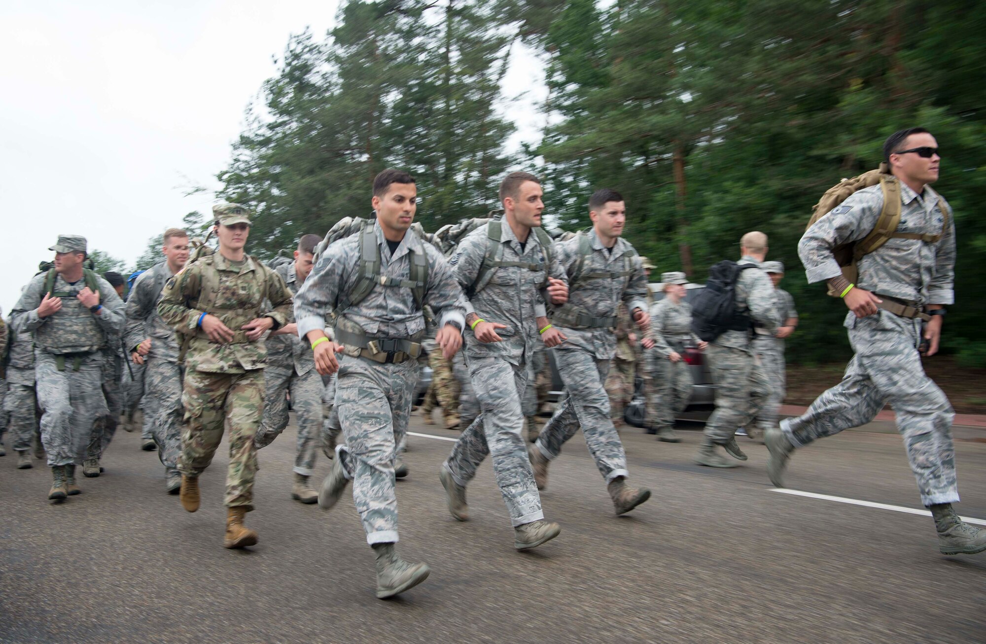 Kaiserslautern Military Community service members run during the Third Annual Chief Master Sgt. of the Air Force Paul Airey Memorial 10K ruck on Ramstein Air Base, Germany, June 1, 2018. Airey endured many trials as a prisoner of war during World War II, before being rescued and later becoming the first chief master sergeant of the Air Force. The memorial events were designed to honor Airey and encourage unit team building. (U.S. Air Force photo by Senior Airman Elizabeth Baker)