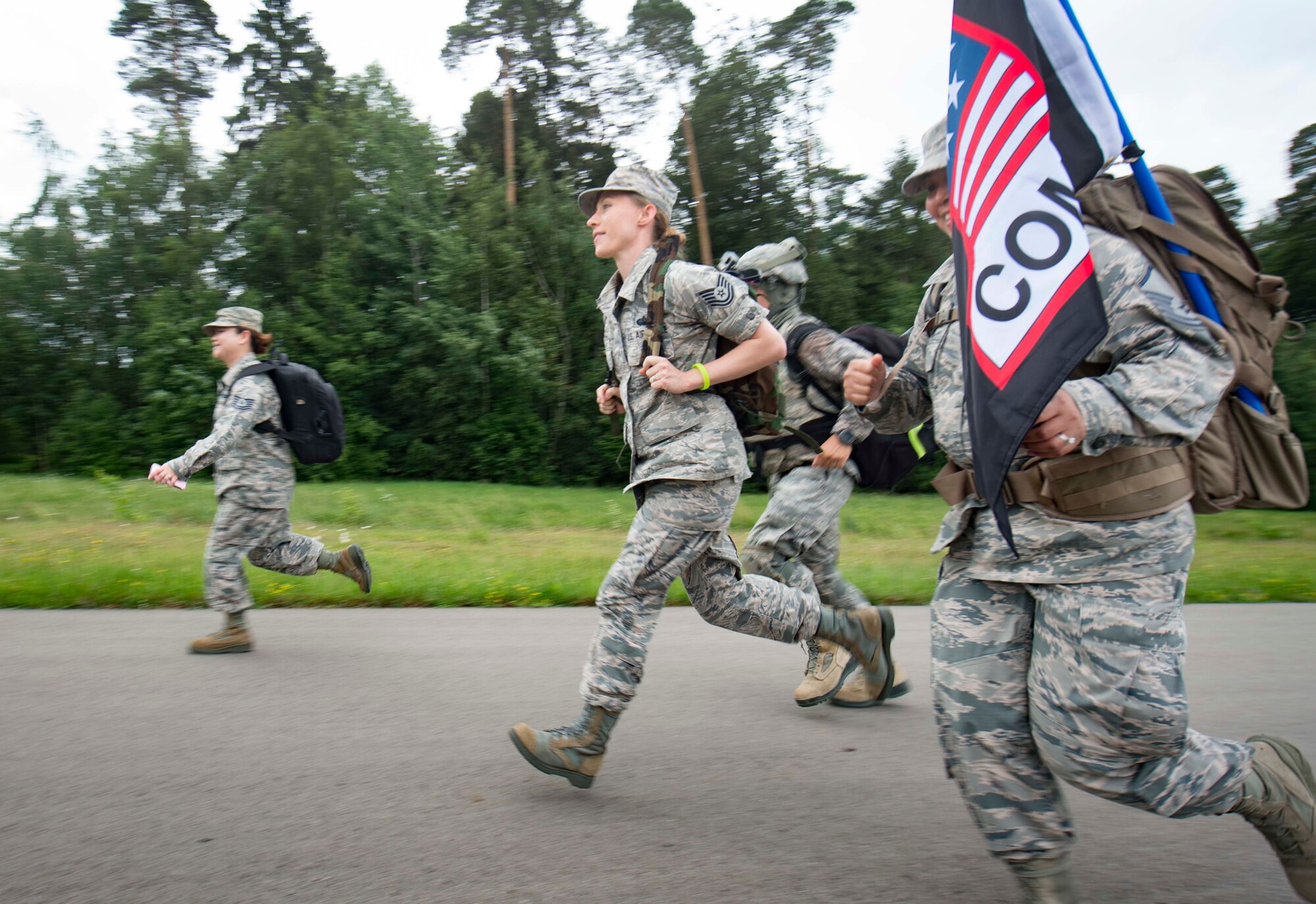 U.S. Air Force Airmen assigned to the 1st Combat Communications Squadron run during the Third Annual Chief Master Sgt. of the Air Force Paul Airey Memorial Ruck/March/Run on Ramstein Air Base, Germany, June 1, 2018. Teams and individuals from the Kaiserslautern Military Community area took on the 5K and 10K walk/run and the 10K ruck march challenge in remembrance of the first chief master sergeant of the Air Force, Paul Airey, who survived a 400-mile march as a prisoner of war in Germany during World War II. (U.S. Air Force photo by Senior Airman Elizabeth Baker)