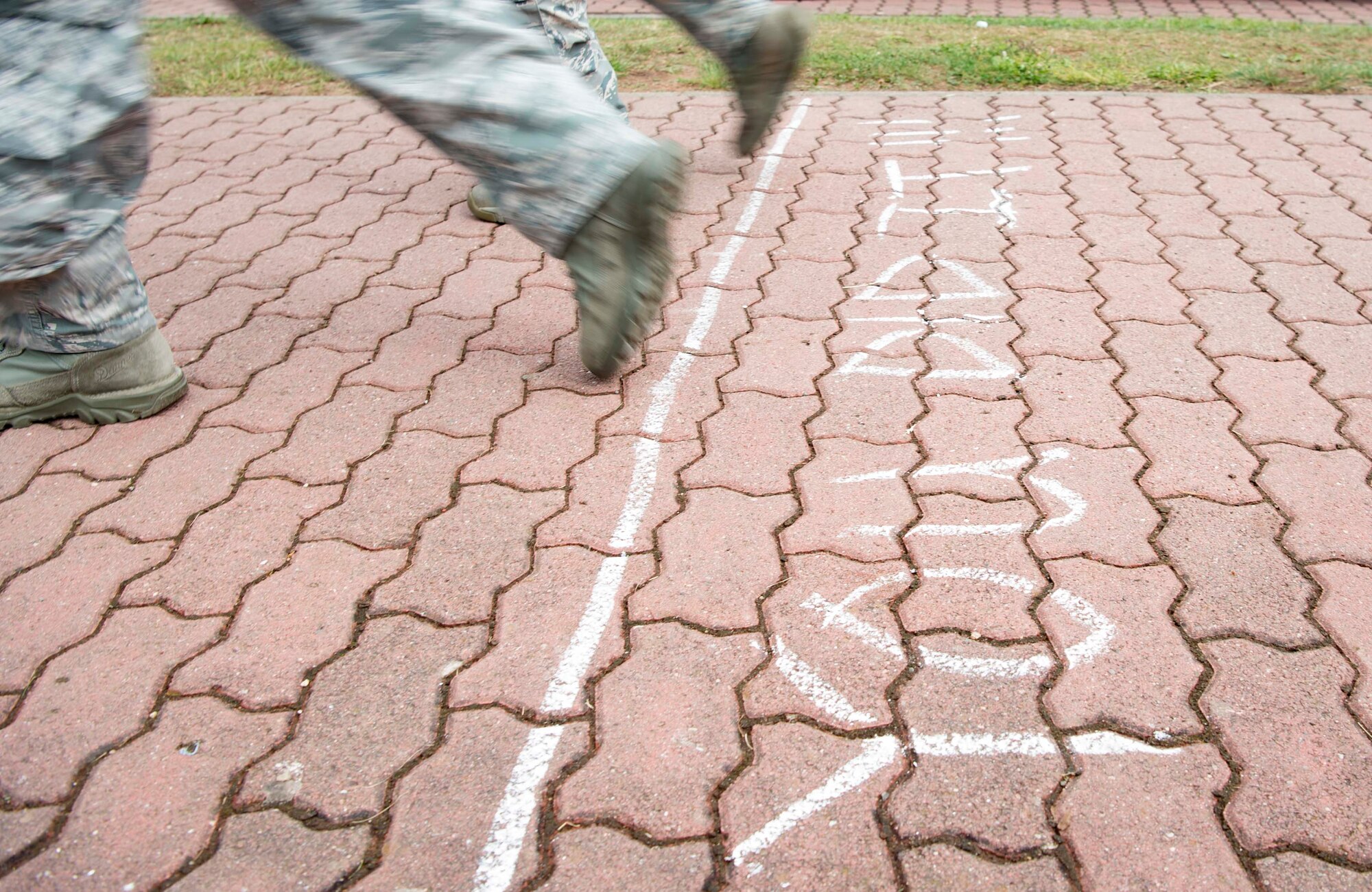 Kaiserslautern Military Community service members cross the finish line during the Third Annual Chief Master Sgt. of the Air Force Paul Airey Memorial 10K ruck on Ramstein Air Base, Germany, June 1, 2018. The events were designed to honor Airey, who endured many trials as a prisoner of war in Germany, including a 400-mile forced-march fraught with cold and disease. (U.S. Air Force photo by Senior Airman Elizabeth Baker)